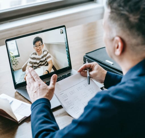 Man on a videocall with a woman using a laptop